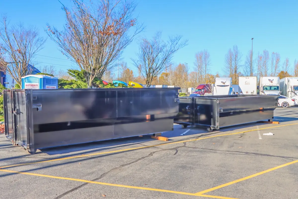 Professional dumpster rental service with roll-off container on residential driveway in South Run